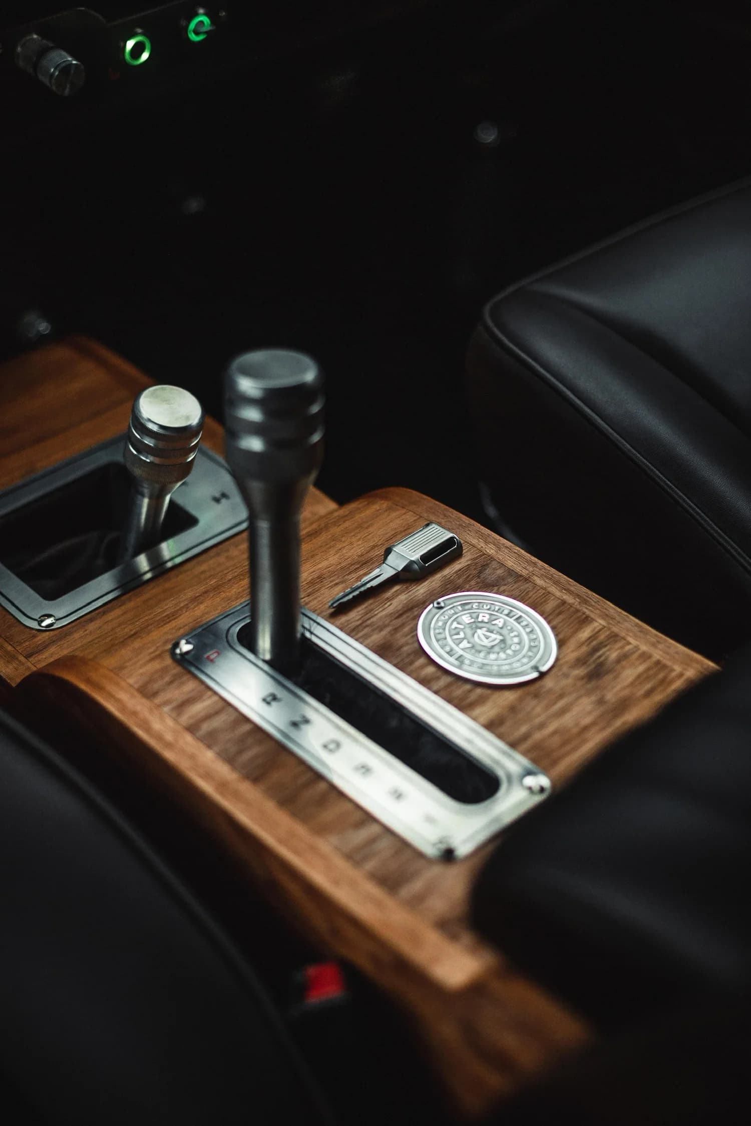 Custom stainless steel Defender key on an Altera timber console